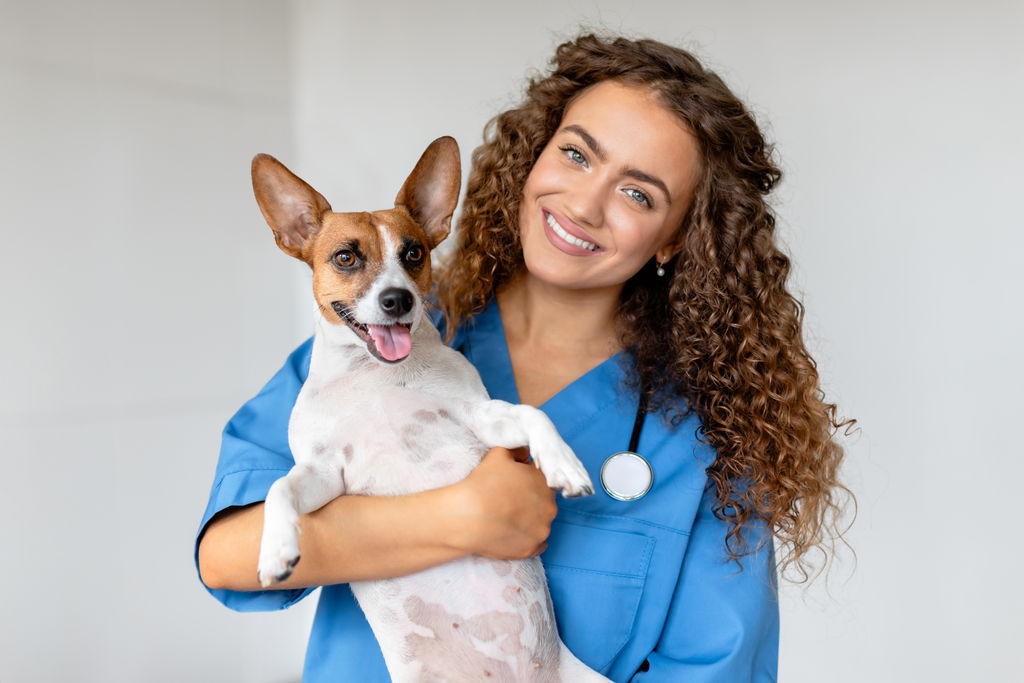 happy-vet-holding-terrier-in-clinic